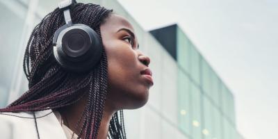 Woman wearing headphones with eyes directed up