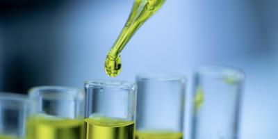 Green fluid dripping into glass tubes