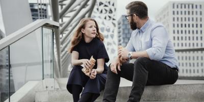 Two people are talking sitting in a staircase